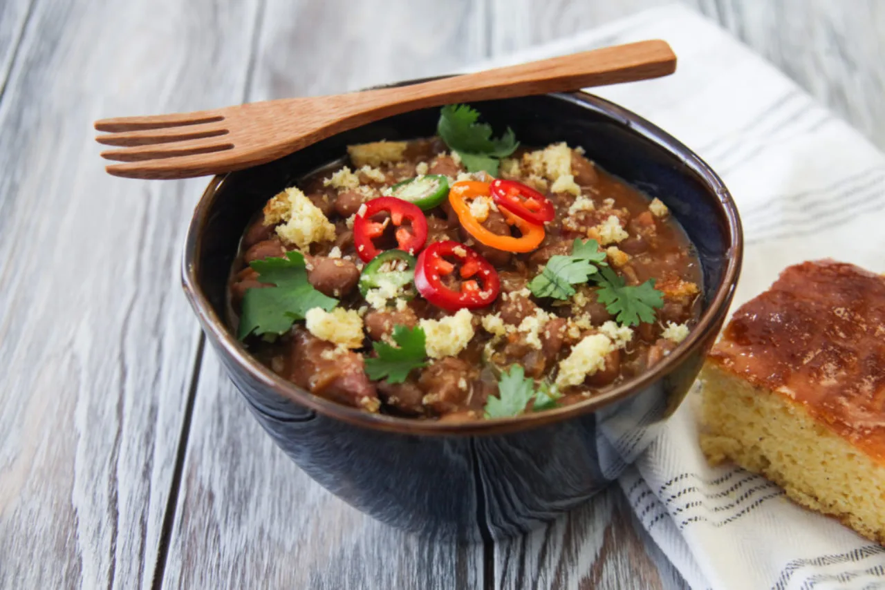 Borracho Beans in a bowl with toppings, made with Carroll Shelby's Original Texas Seasoning.