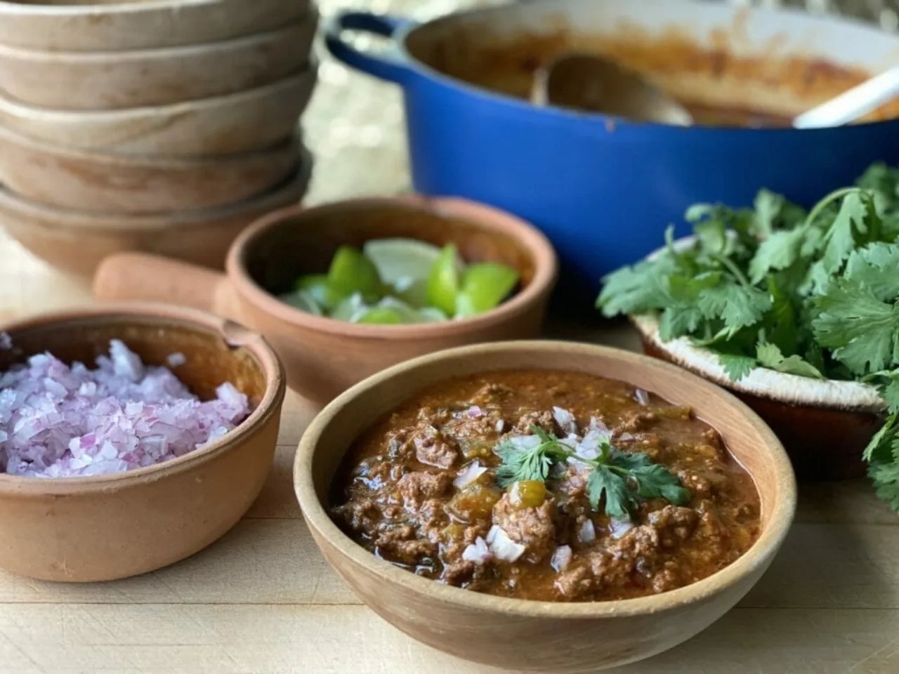 tomatillo chili in a bowl with toppings